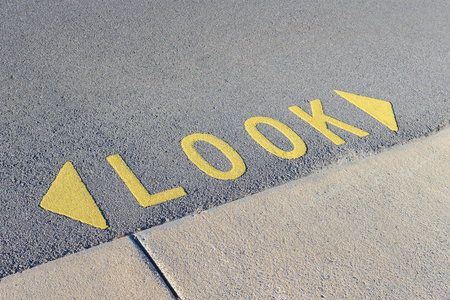 Look wordings and arrows in yellow on the roadの写真素材