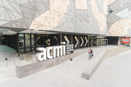 Melbourne, Australia - July 29, 2016: A man walking pass the Australian Centre for the Moving Image in Federation Square, Melbourne. The centre promotes film and digital media to the public.のeditorial素材