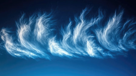 Wispy and dense clouds blending together over a brilliant blue canvas in the open skyの素材