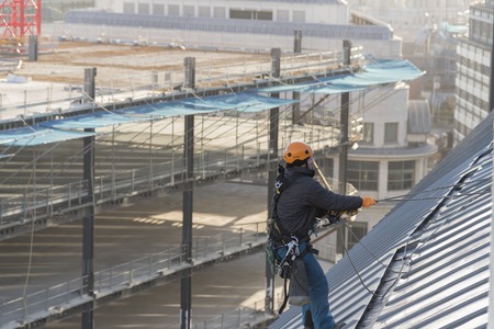 Industrial abseiler on the rooftopの写真素材