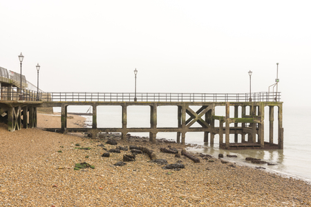 Old pier with a view of a beachの写真素材