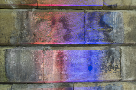 Texture of old stone blocks with colour light shining at themの写真素材