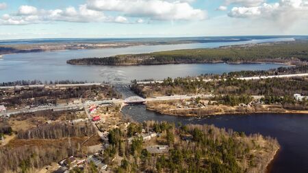 Aerial view of the Vuoksi river, the forest and the settlement in autumn day, Losevo, Leningrad...