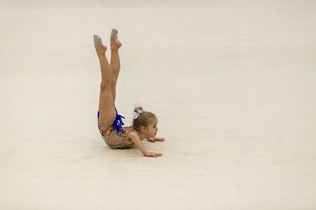 Portrait of a young gymnast. Portrait of a 7 years old girl in rhythmic gymnastics competitionsの写真素材