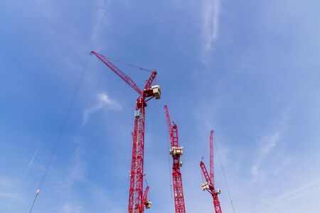 Construction site with cranes on sky backgroundの写真素材