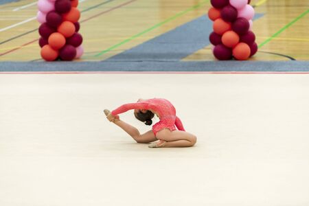 Portrait of a young gymnast. Portrait of a 7 years old girl in rhythmic gymnastics competitionsの写真素材