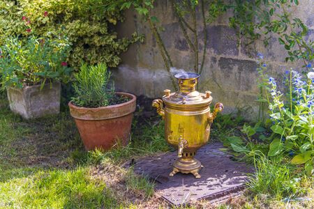 Old vintage samovar with smoke. Brewing tea in the old fashioned way. Russian ceremonyの写真素材