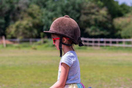 Horseback riding, lovely equestrian - young girl is riding a horseの写真素材
