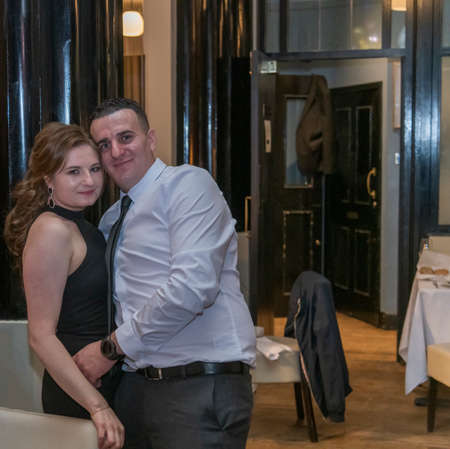 Beautiful couple hugging in the restaurant, London, UKの写真素材