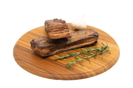 Delicious artisanal whole smoked slab bacon on a cutting block.の写真素材