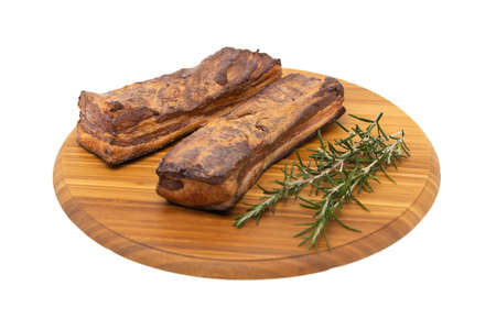 Delicious artisanal whole smoked slab bacon on a cutting block.の写真素材