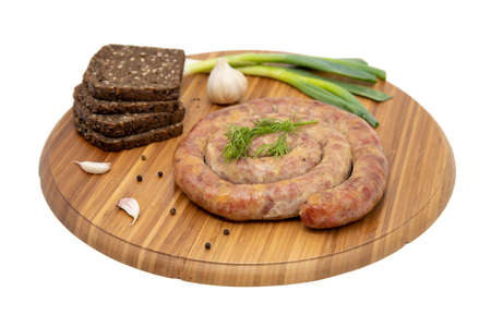 Coiled cumberland sausage with garlic rustic boardの写真素材