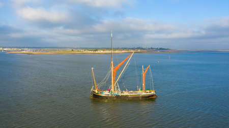 Beautiful aerial view on vintage caravel on sunlit sea water. Scenic travel concept, Brightlingsea, Essex, UKの写真素材