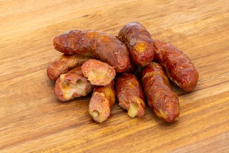 Delicious Snack Sausages, Neatly Arranged on a Rustic Wooden Surface Ready to Enjoyの写真素材
