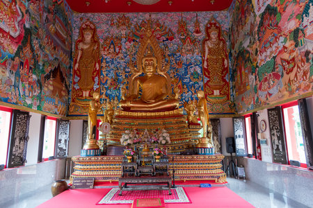 The Serene Figure of Buddha Found Within a Beautiful and Colourful Temple Settingの写真素材