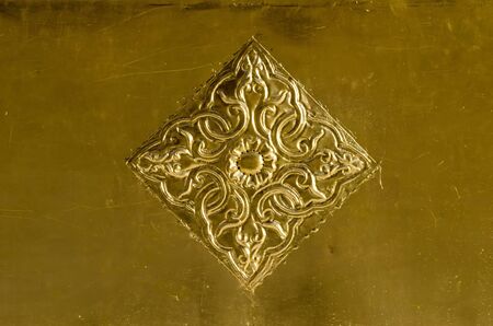A carved brass plate use to decorate in Buddhist templeの写真素材