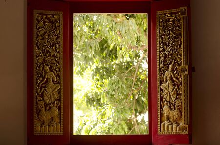 Temple's window that decorate with angel sculptureの写真素材