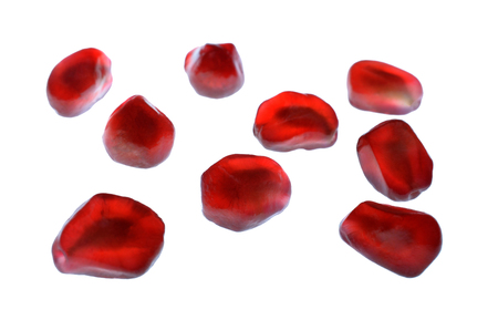 Silhouette pomegranate seeds, select focus image on group of pomegranate seeds isolated on white bright background, red seeds of pomegranate after peeled, tropical fruit healthy food, fruit grainの写真素材