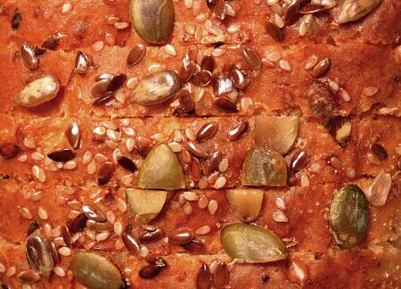 Cereal bread texture, a top view closeup photo image of a sliced cereal bread loaf present a detail of cereal grain on a surface of bread, wholewheat brownbread, healthy food, brownbread backgroundの写真素材