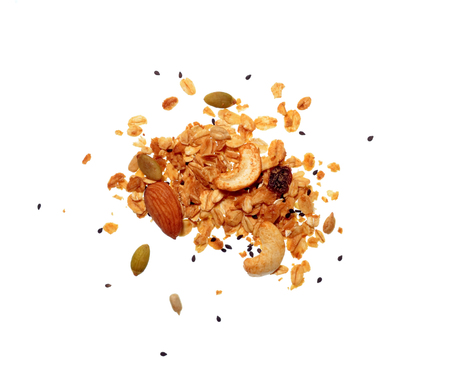 Isolate granola/muesli grain, a top view close photo on granola/muesli pile present a detail in top view of granola/muesli grain isolate on white bright light background, a cereal grain healthy foodの写真素材