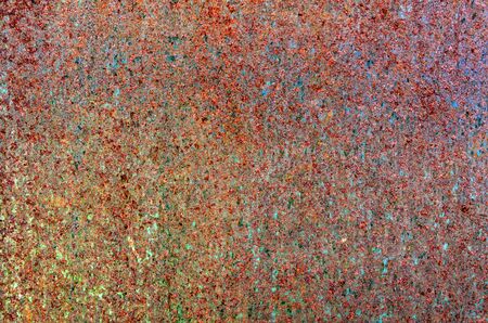 Colorful grunge rust stain texture, rusty copper wall, a close up photo of colorful grunge rust stain on a rusty copper wall present a detail of a grunge rust stain texture on that rusty copper wallの写真素材