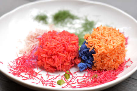 Colorful cooked rice that coloring by plant pigment, colorful cooked rice ball with vegetables on white dish/plate, organic healthy food, art of food cooking, art cooked rice, food coloringの写真素材
