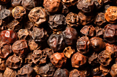 Dried black pepper grains texture, a close up photo image on surface of dry black pepper grains pile present a detail of texture on surface of dried black pepper grains, can use for a backgroundの写真素材