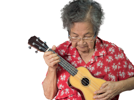 Old Asian Woman Playing The Ukuleleの写真素材
