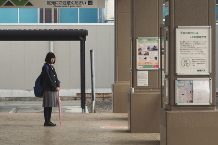 Matsumoto, Japan - 15 MARCH 2016 : Unidentified girl waits the bus at bus terminal in the morning.