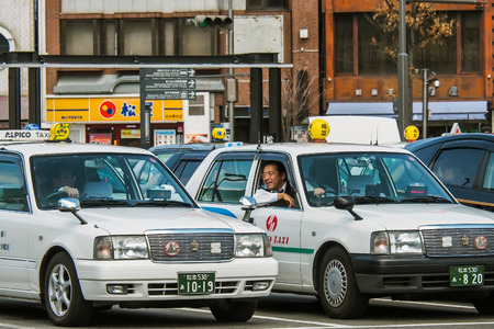 Matsumoto, Japan - 15 MARCH 2016 : Unidentified Japanese taxi driver man sits in his car and opens his glass car to talk with his friend.のeditorial素材