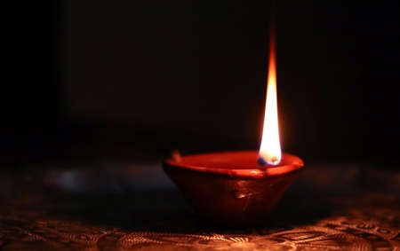 Clay diya lamps lit during Diwali Celebration. Hindu Light Festival called Diwali.