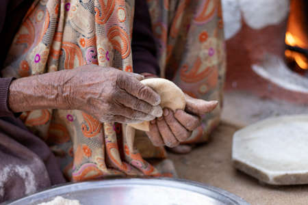Senior woman hand making chapati. selective focusの写真素材