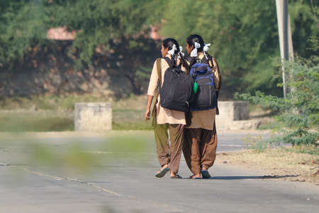 Jaipur, Rajasthan, India- November 24, 2021: Two adult girl going school.