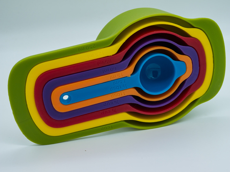 Colorful plastic measuring cups set and measuring cups different sizes on white background.の写真素材
