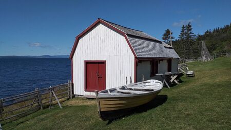 Canadian barn and fishing boat - are the castles of the country Canada. Ocean viewの写真素材