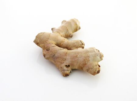 Fresh raw organic ginger root on white background.Overhead of gingers on white backgroundの写真素材