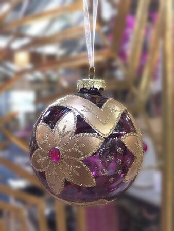 Christmas Ornament Elegant violet crystal ball with golden flowers. Silver and gold glitter. Satin Bow Abstract backgroundの写真素材