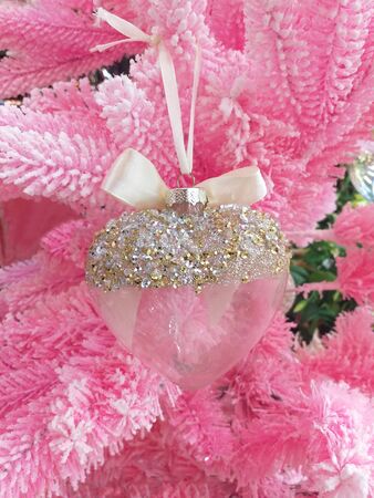 Christmas Ornament Christmas composition Crystal heart with silver and gold glitter. Satin Bow Christmas tree pink.の写真素材