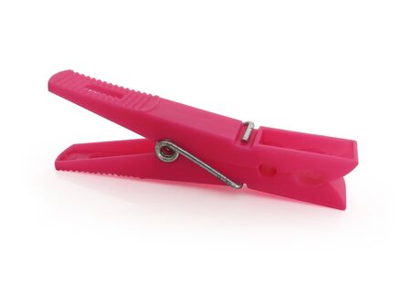 Pink plastic clothespin isolated on white backgroundの写真素材