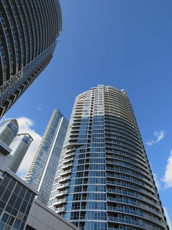 View of a skyscraper in downtown Toronto in Ontario Canada. Toronto skyscrapers close-up. Financial district Blue sky contrasts with the metallic buildings.のeditorial素材