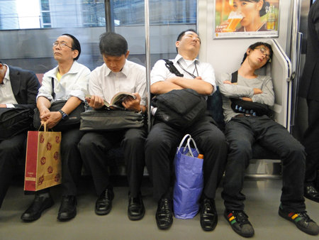 Tokyo, Japan; September 18,2010: Image of Japanese men of different ages in the subway. White shirt, pants and black shoes. Inemuri: Sleepy in the subwayのeditorial素材