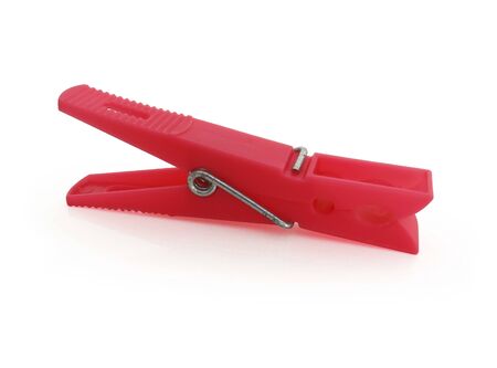 Horizontal view. Isolated red plastic clothespin on white backgroundの写真素材