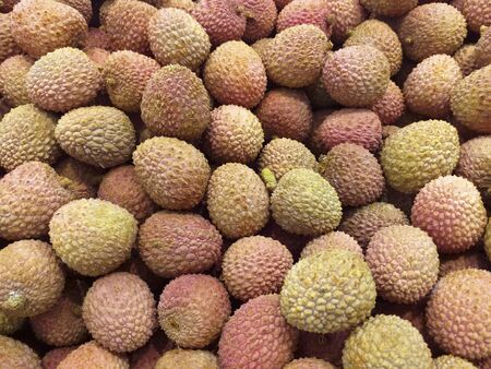 Close up view of organic lychee piled for sale. Fresh litchi tropical fruit.の写真素材