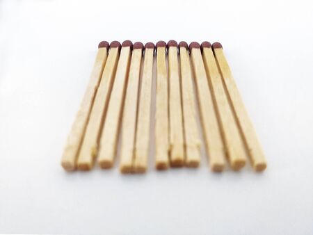 Perspective view of Piles of brown matchstick isolated on white. Wooden rods with a flammable head...