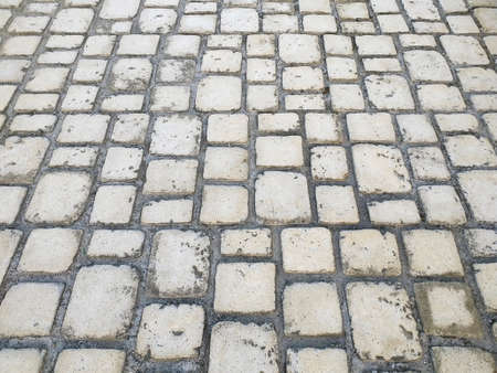 Aerial view of stone brick pavement of various shapes and sizes with light cement. Surface texture....