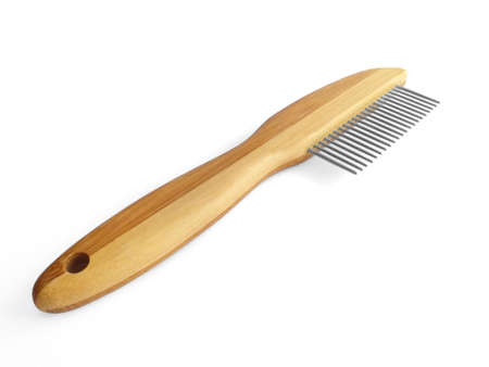 Wooden pet bristle brush isolated on white background. Care of the coat of dogs, cats with a brush...