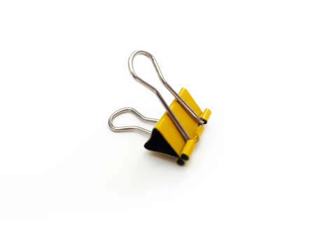 Yellow blinder clip isolated on whiteの写真素材