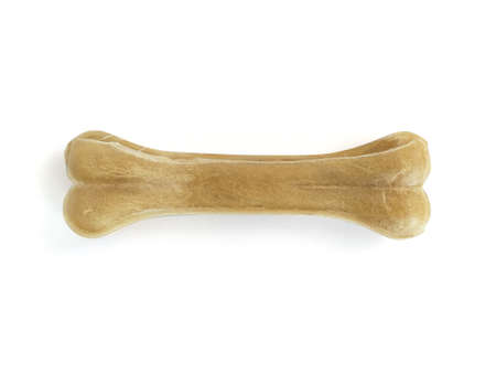 Pressed bone shaped Teether for dog puppies isolated on white background. Close up. Pet Dog Toy...