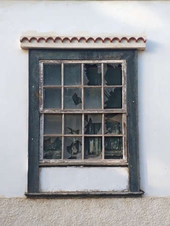 Traditional guillotine window in historic colonial house. Front view of closed old sash window on...