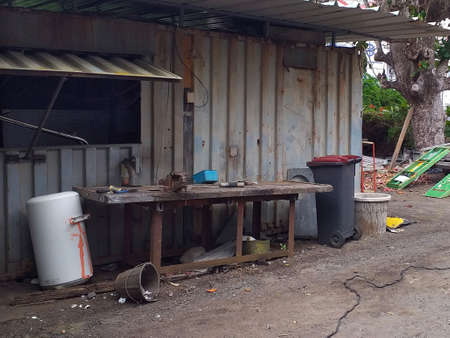 Old sheet metal facade of a Caribbean workshop in the French West Indies. Rusty metal, tropical...